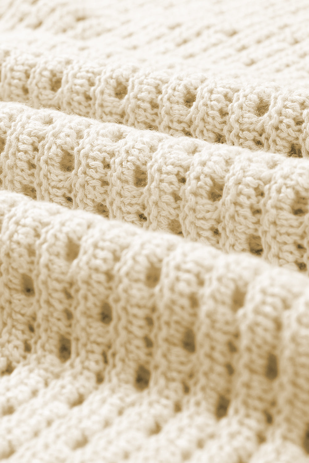 Aprikosenfarbener pointelle-strick-baggy-pullover mit farbblockmuster