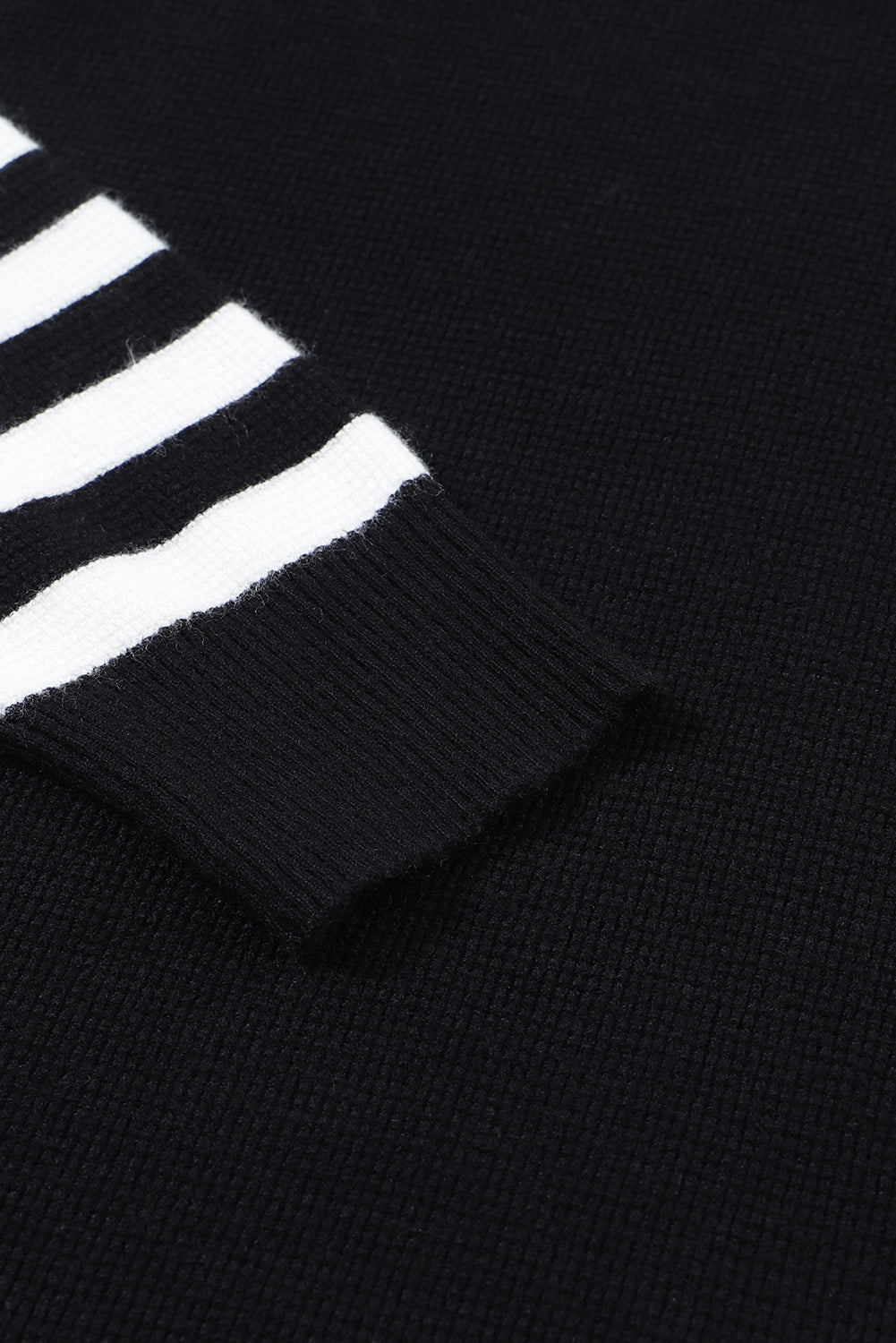 Schwarzer pullover mit gestreiften ärmeln und einfarbigem strick
