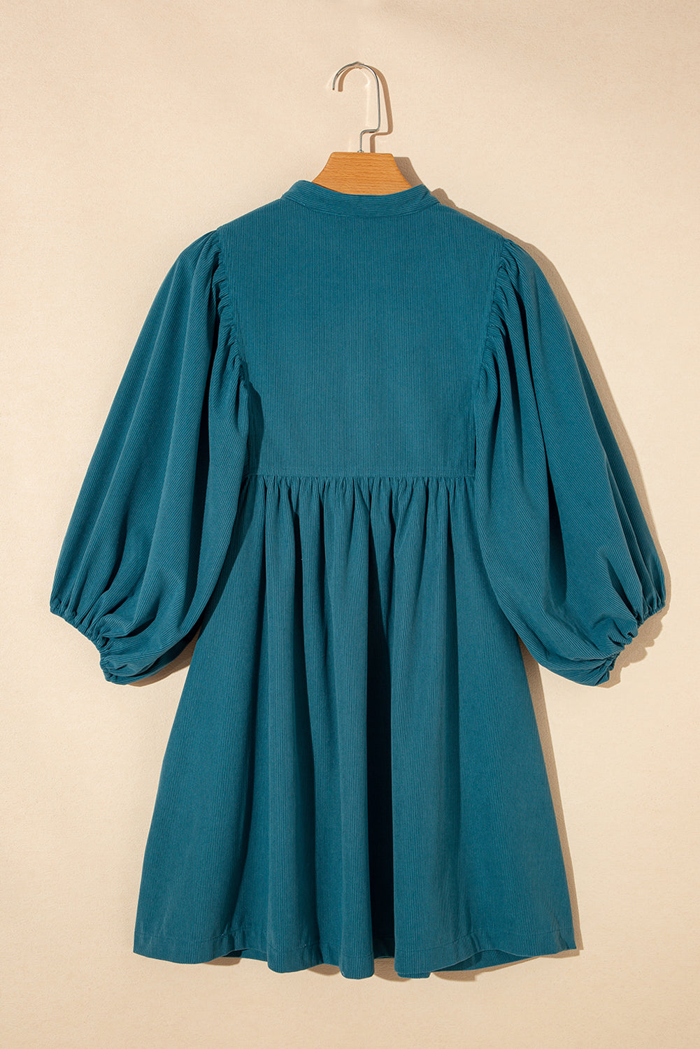 Blaues cord-knopf-kleid mit empire-taille und armband-ärmeln