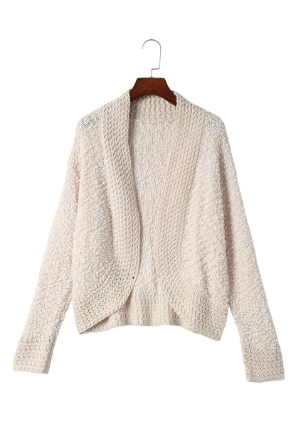 Aprikosenfarbener popcorn-strickcardigan mit offener vorderseite