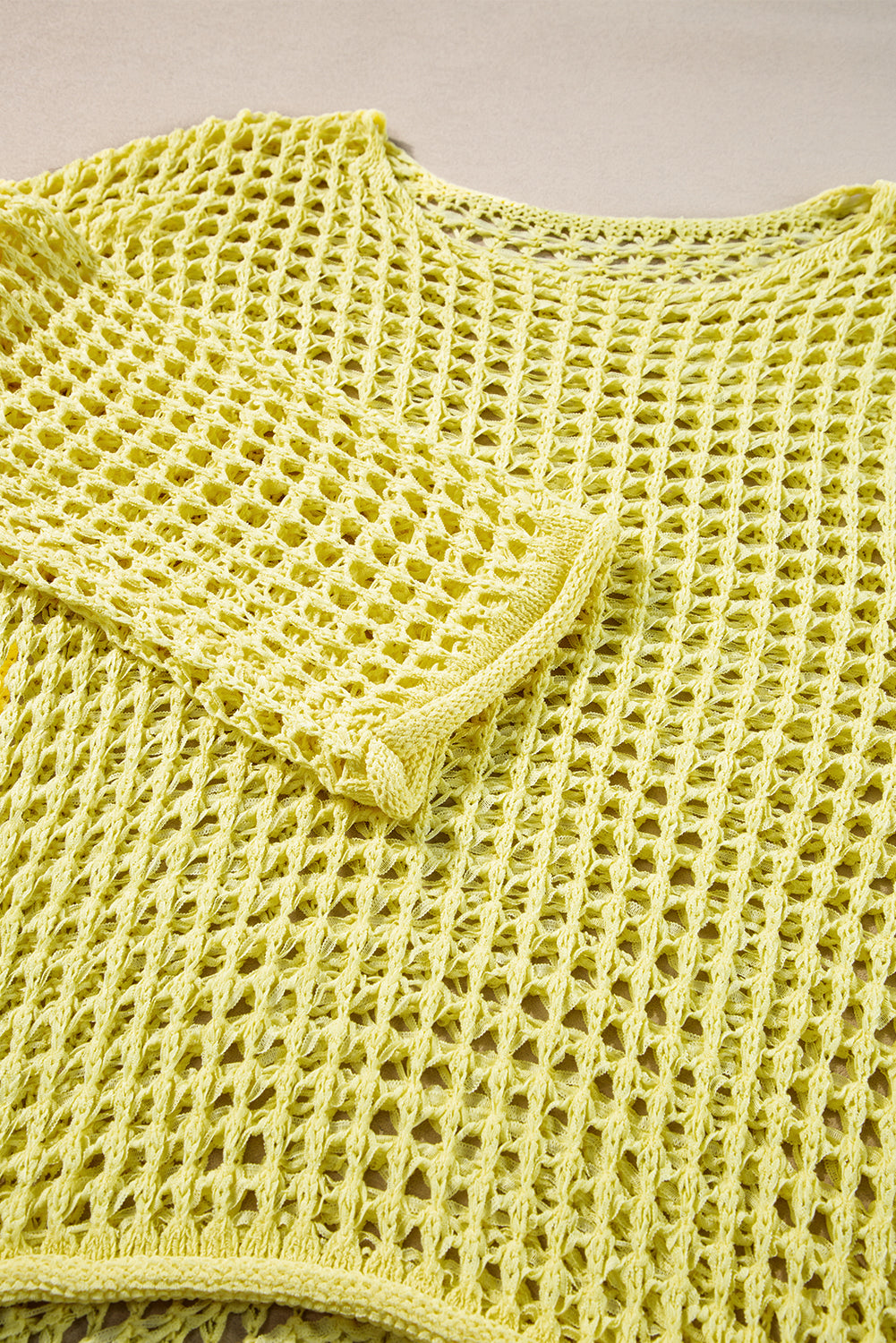 Gelber tunika-pullover mit glockenärmeln und offenem strickmuster