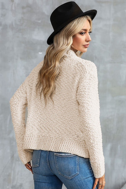 Aprikosenfarbener popcorn-strickcardigan mit offener vorderseite