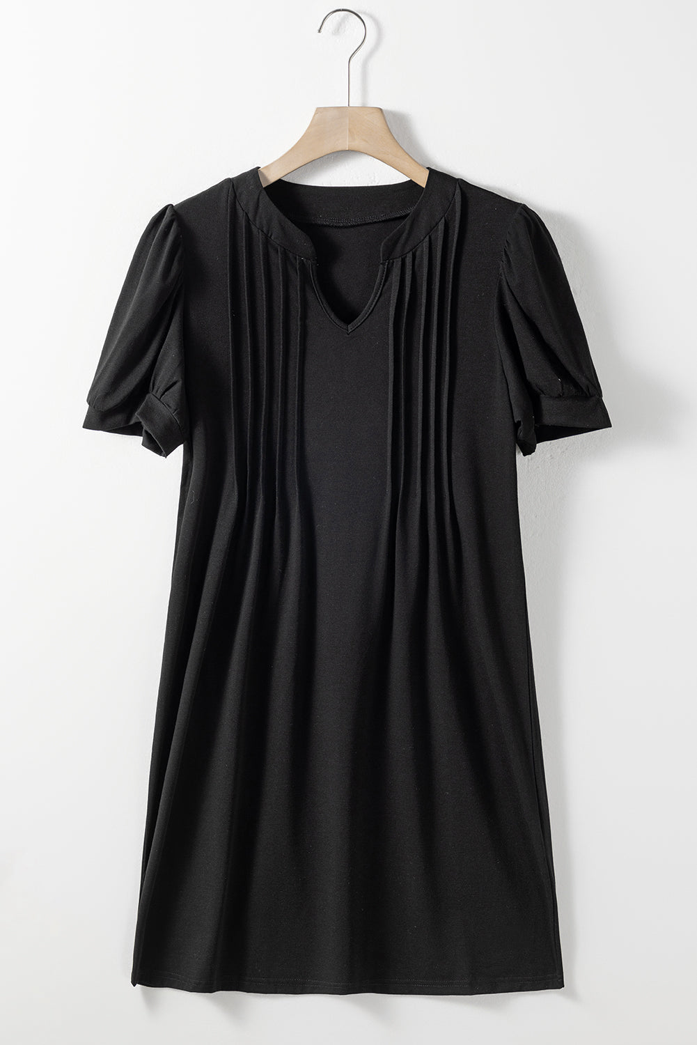 Schwarzes t-shirt-kleid mit plissiertem ausschnitt und puffärmel