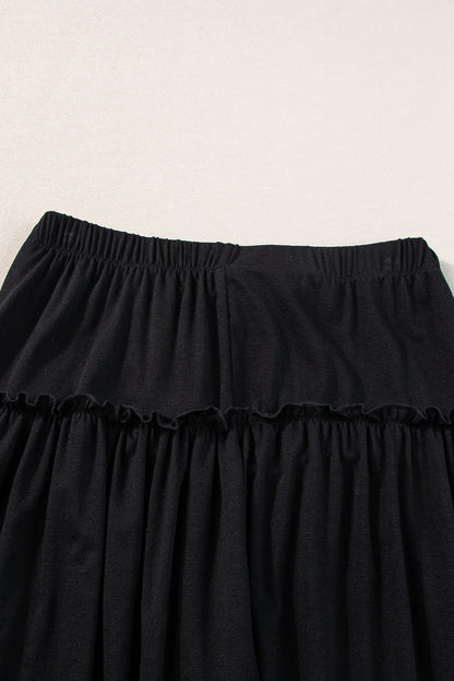 Schwarze gerüschte hose mit weitem bein und hoher taille mit kordelzug